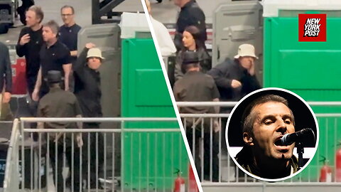 Oasis frontman Liam Gallagher jokingly gestures to fans that he's snorting drugs in a porta-potty
