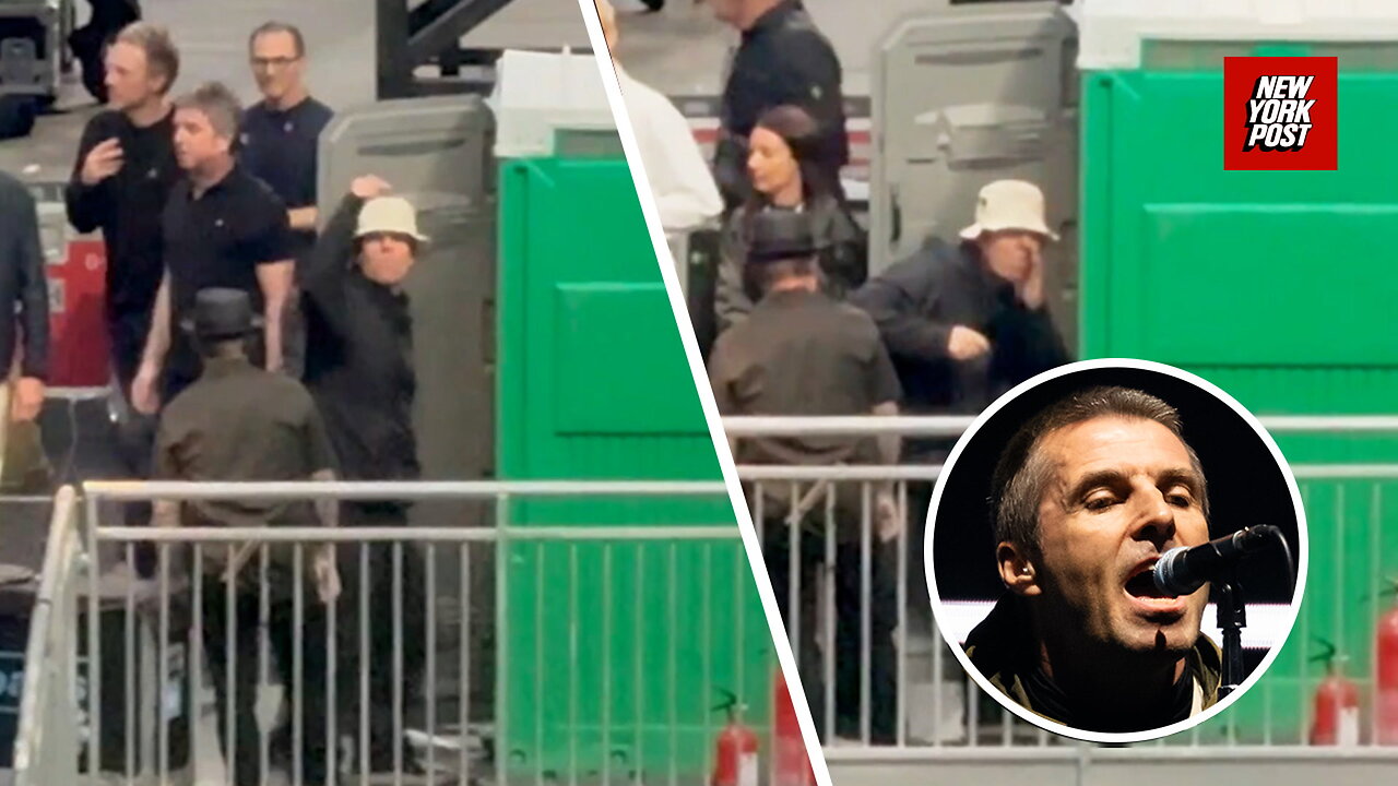 Oasis frontman Liam Gallagher jokingly gestures to fans that he's snorting drugs in a porta-potty