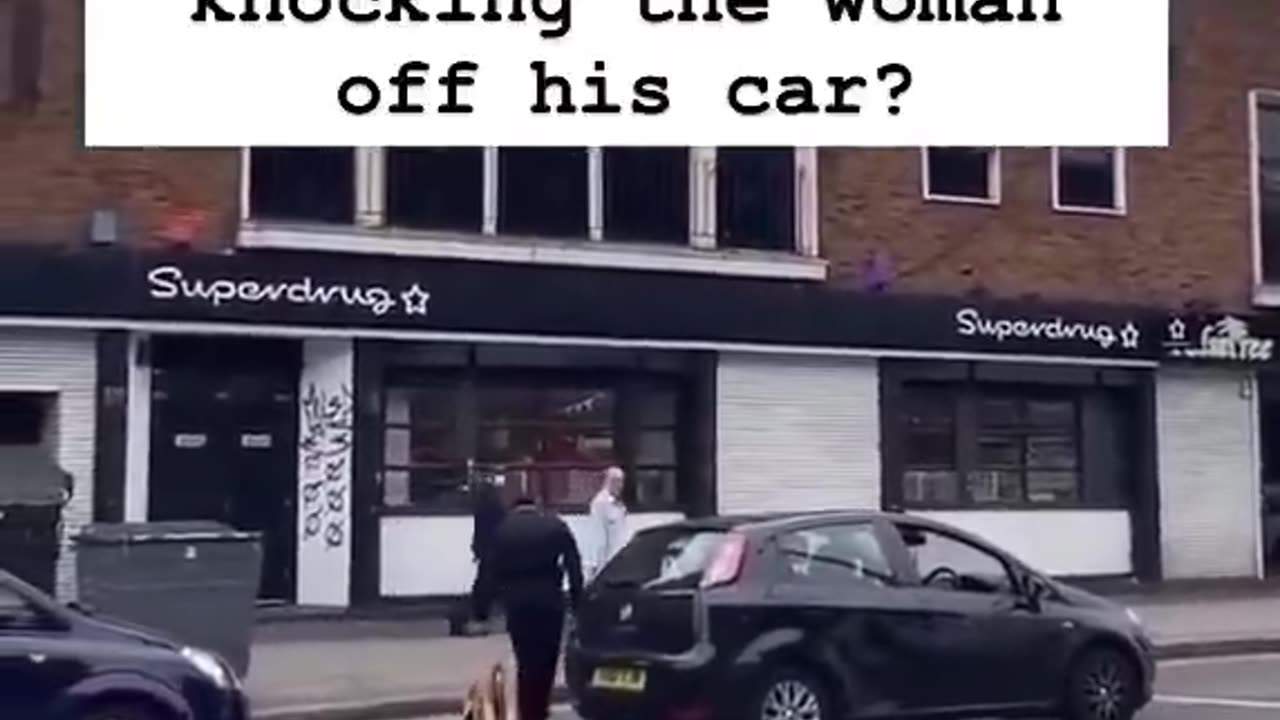 Woman steps on a man's car. Man pushes her off.