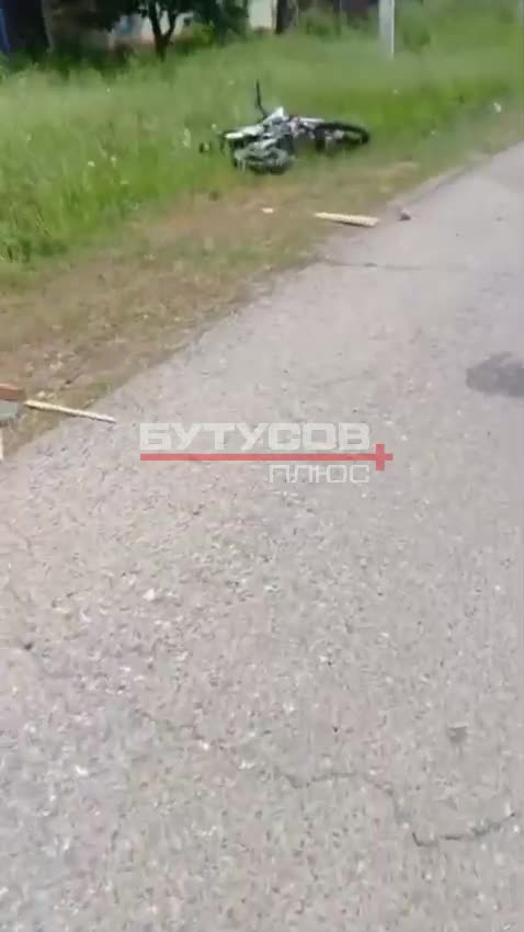 Russian Soldiers Stop to Examine Comrades On Side of Roadway