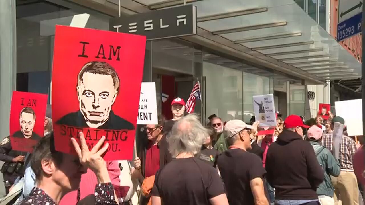 Protesters march outside Tesla showroom in New York City