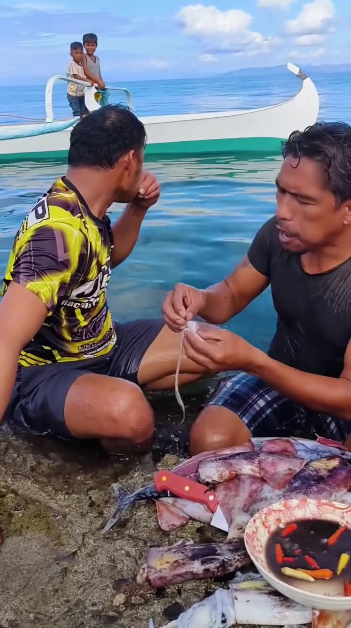 Eating raw squid from the sea