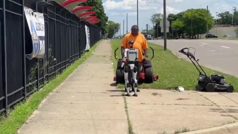 Humanoid robot spotted casually walking down a Detroit road, shaking hands with people