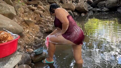 My clothes are washing in the river