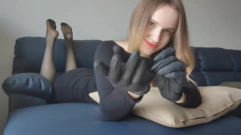 The pose in black latex gloves