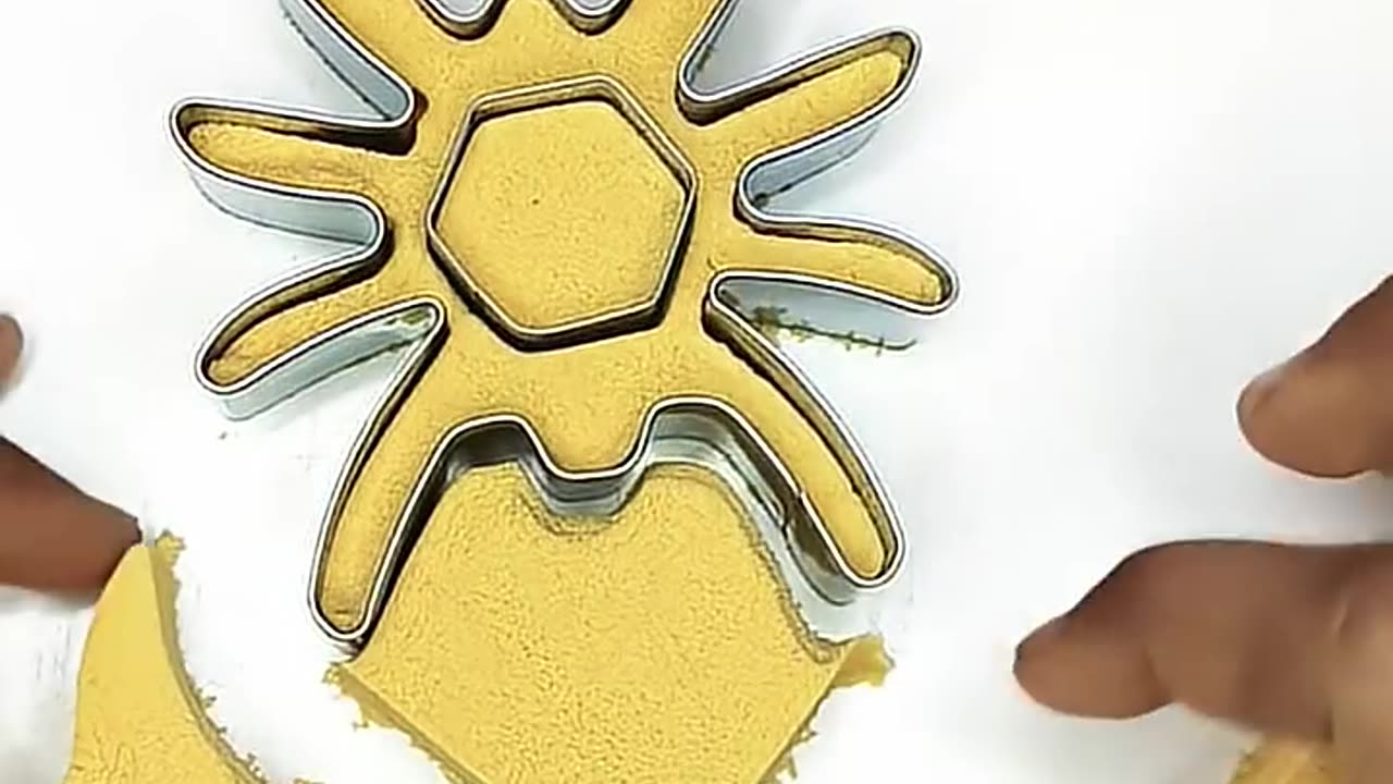 A spider takes shape from yellow sand ✨