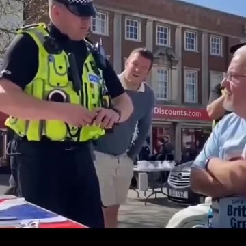 A British officer warns an elderly man that saying “Speak English” could be a hate crime.