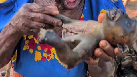 African Woman Eating a Monkey
