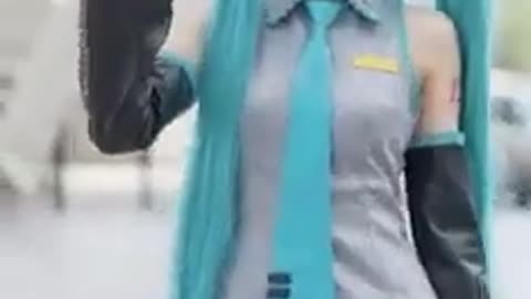 East Asian girl Hatsune Miku Cosplayer Saying Hi