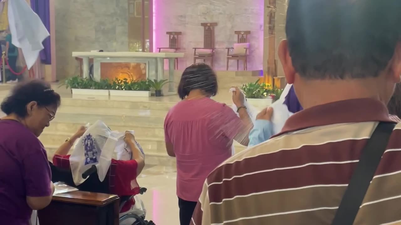 Priest Uses Water Pump to Give Final Blessing
