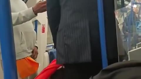 A man on the Victorian Underground line threatens two well dressed men