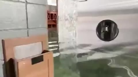 Owner fills restaurant with fresh water to stop muddy flood waters from entering.