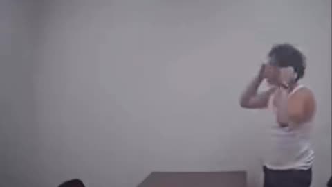 Man escapes the interrogation room by kicking a whole in the wall