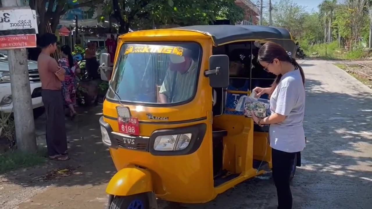 Riding in a three Wheeler to Dr Min's Clinic