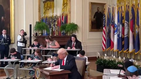 President Donald J. Trump signs an Executive Order to eliminate the