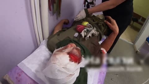 Severely Wounded Russian Soldier Holding On to Apple While Being Examined