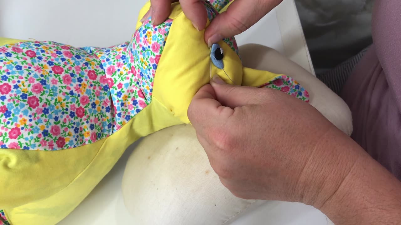 Sewing Eyes on Cat Sculpture