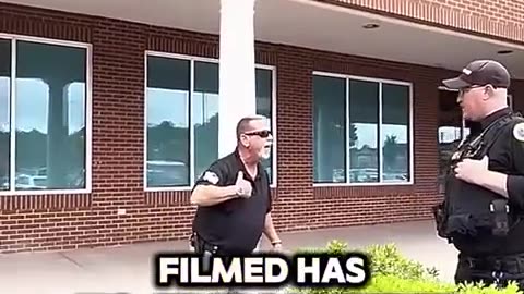 Security guard doesn't realize the rules of the building do not trump laws.