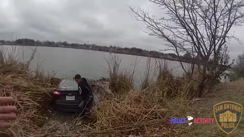 a black guy drives his car into pond than tries to STAB officer