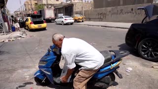 Iraqis battle extreme heatwave with ice, mist and river dips