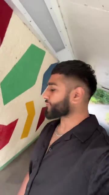 An Arab Muslim living in UK spits on the St George's Cross because he hates British people.