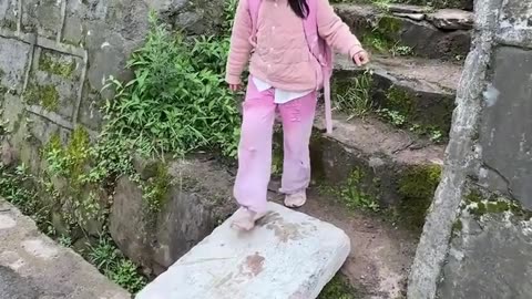 A little girl struggles to reach the stairs!.hd