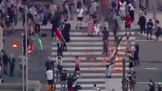Outside of City Hall in Philadelphia, masked pro-Palestinian Islamists light dozens of American