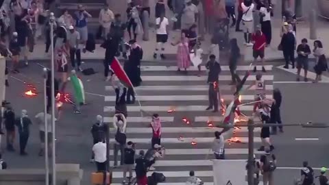 Outside of City Hall in Philadelphia, masked pro-Palestinian Islamists light dozens of American