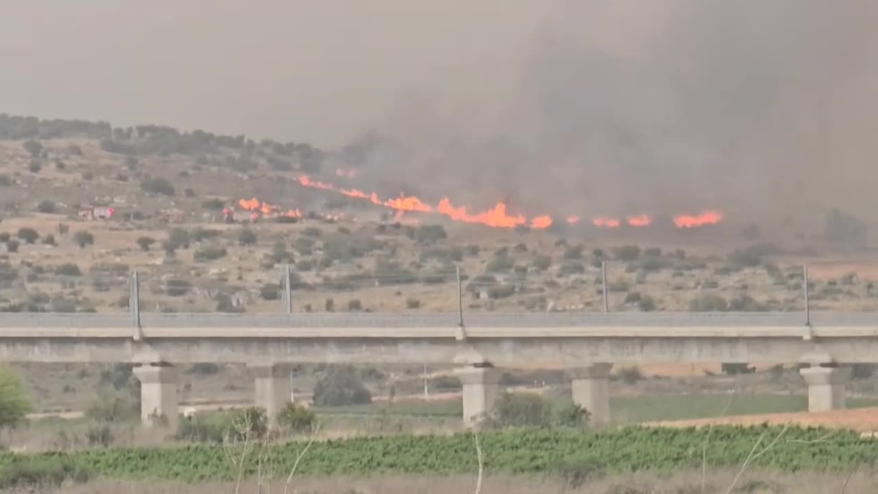 At the entrance to Modi'in: Firefighters work near the railway bridge to stop the flames