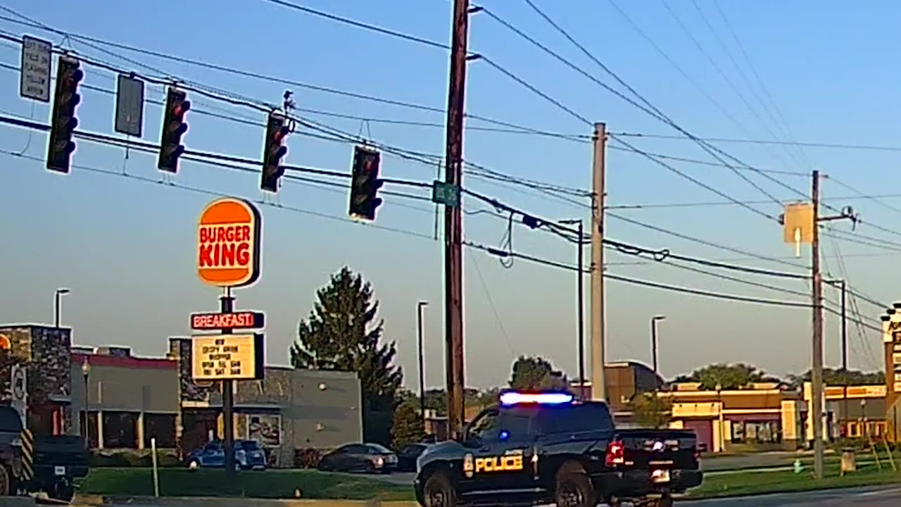 Rolling Coal Next to Cop Car