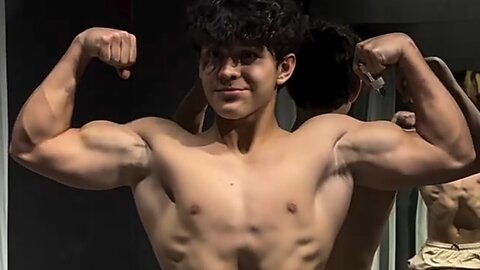 15 years old teen bodybuilder flexing muscles