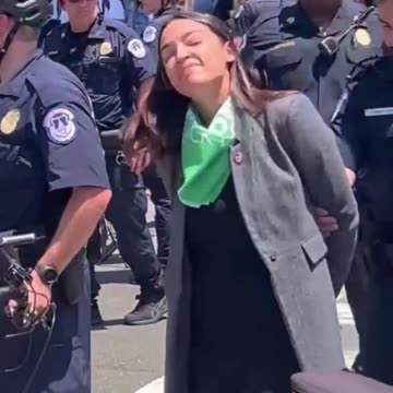 In 2022, AOC staged a photo op, pretending to be Cuffed