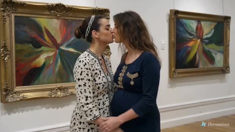 Lesbian kiss between two women in an art gallery