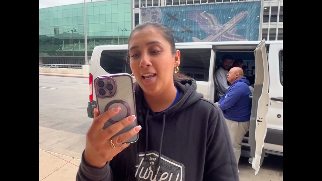 A white van of illegal aliens are being held up at the departure terminal