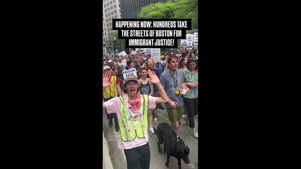 Activists opposing ICE policy march through Boston, showing support for undocumented migrants.