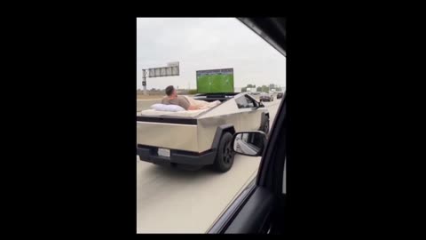 A Cybertruck owner watching football on TV while driving with FSD!