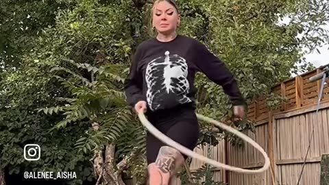 Woman Hanging on Her Hair and Hula Hooping