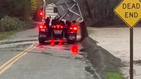 A truck in Whatcom County dumped large amounts of sand to help divert rising floodwaters
