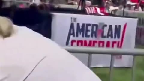 Man In Brown Shirt Jumps Rail To "Help" Charlie Kirk After Shooting Him With Palm Pistol