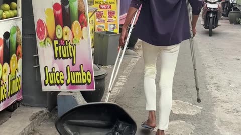 Walking Man Casually Holds Crutches Out