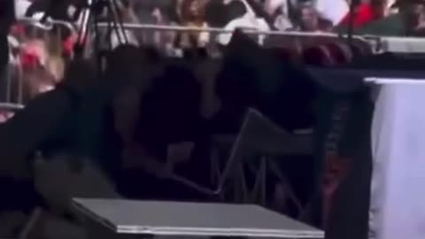 CHARLIE KIRK SHOOTING - Side view - Chair goes through table？