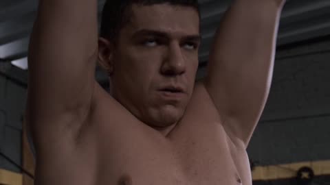 A muscular shirtless young man doing squats and lifting dumbbells on his fitness routine