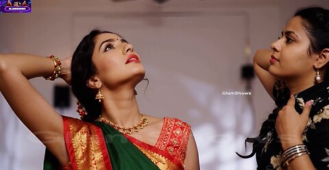 Young lady getting saree draped by her aunty - GlamShows