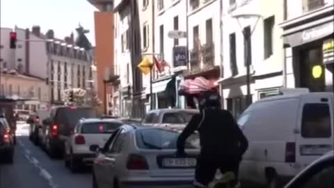 This biker climbs on parked cars with his motocross bike