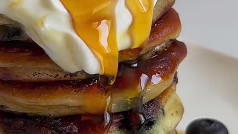 Blueberry pancake with cream and honey