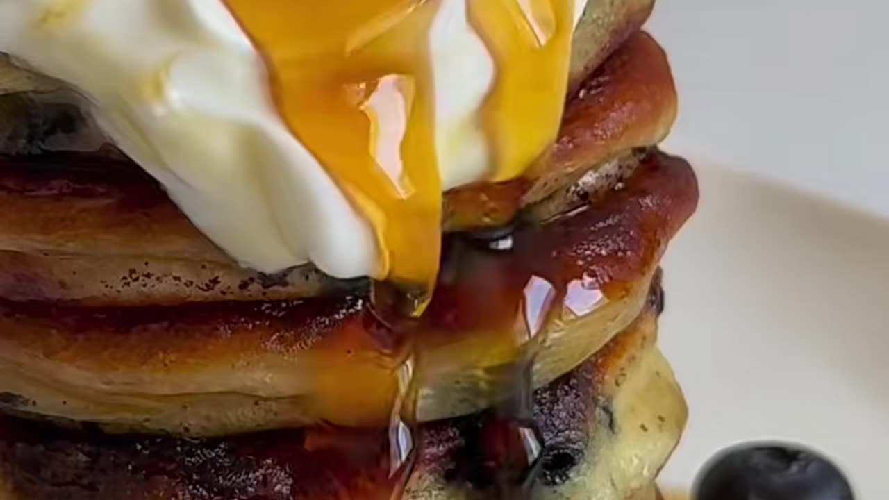 Blueberry pancake with cream and honey