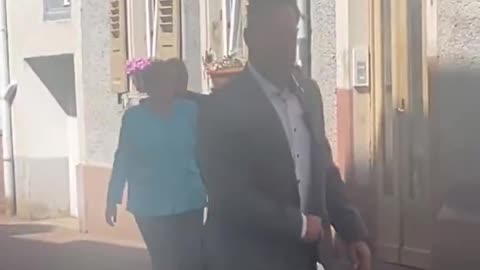 Merkel, who has flooded our cities with criminals, walks around protected by