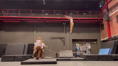 Stomach Stunt On Seesaw By Circus Acrobats