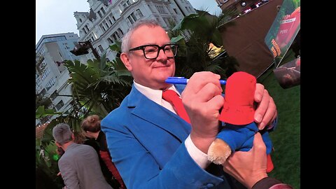 HUGH BONNEVILLE signs a Paddington Bear for charity / Woking & Sam Beare Hospice 3/11/24