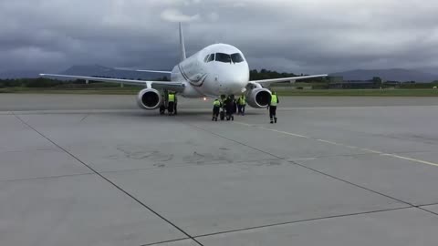 At Bodø Airport (Norway),the ground staff of CityJet manually tows a Sukhoi Superjet 100 aircraft